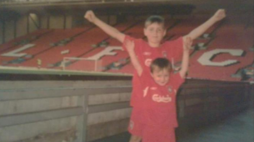 Accrington Stanley forward Josh Woods (front) aged five wearing his Liverpool kit in front of the Kop in 2005