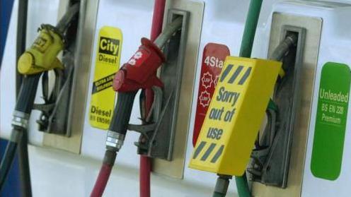 Three pumps at a petrol station, the unleaded pump has a "sorry out of use" label over it. 