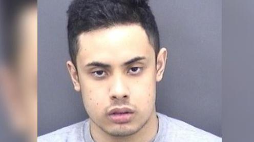 Police custody photo of Nasen Saadi. He has short black hair, dark eyes and is looking to camera