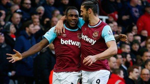 West Ham's Michail Antonio celebrates scoring against Liverpool with former Reds striker Andy Carroll