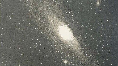 A cluster of shining "blobs". The objects towards the centre are brightest, though dark lines block out a portion of the visible image