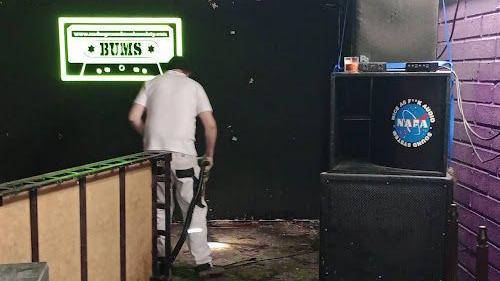 A volunteer at the Barrow Underground Music Society cleaning up around the damage stage area.