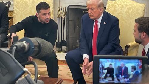 Zelensky, Trump and JD Vance seated in White House. They are seen on a camera viewfinder in the foreground