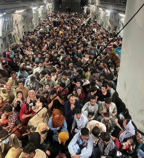 Evacuees crowd the interior of a U.S. Air Force C-17 Globemaster III transport aircraft departing Kabul.