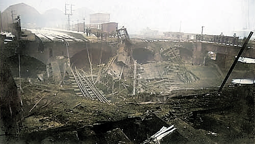 An old photograph of the collapsed railway station after the fire.