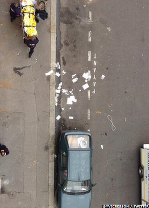 This image was tweeted with the text: "A second seriously injured person is taken out #CharlieHebdo"