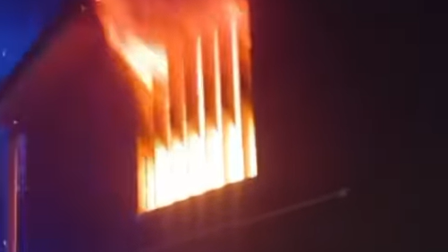 Flames coming out the side of a building