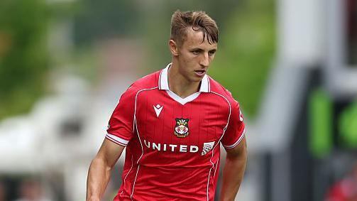 Max  Cleworth in action for Wrexham during a game against Sheffield Wednesday