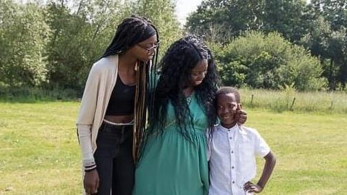 Haddy Folivi, flanked by her two children