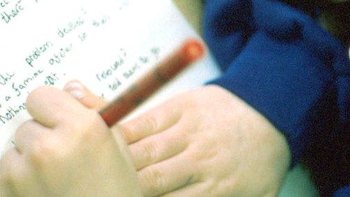 Child writing on paper