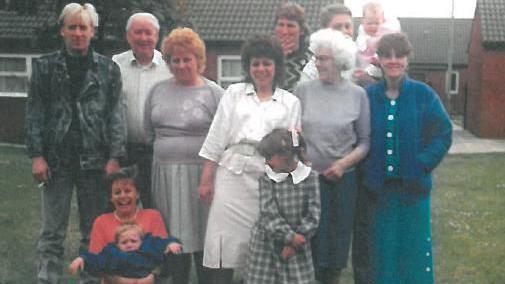 A large family group from the 1990s with Nora Tait the third on the left.