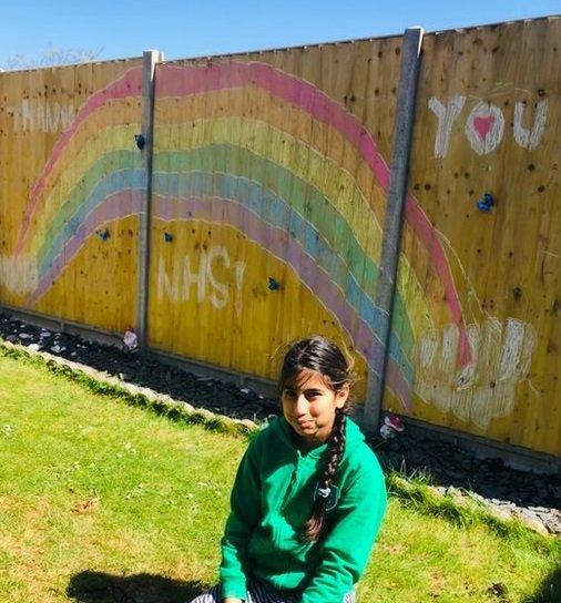 Ikshu cheered up her wooden fence with a rainbow - and she has stylish zebra trousers to match too!