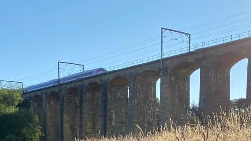 A transpennine train crossing the viaduct just outside Alnmouth station 