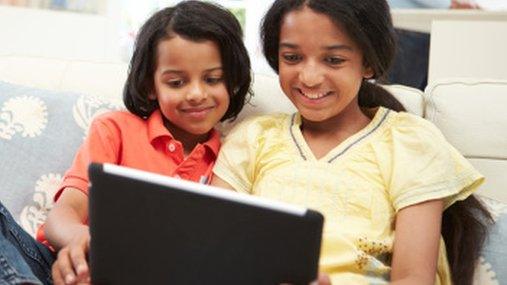 Indian girls play with a tablet