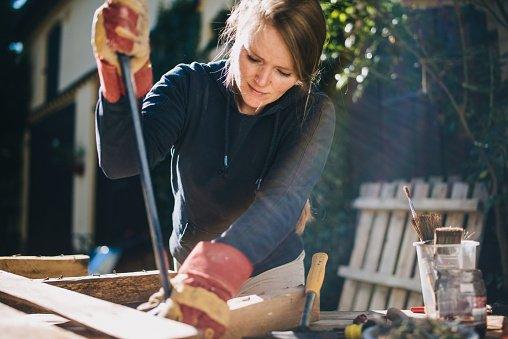 Woman doing DIY in backyard