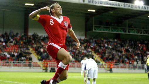 Craig Bellamy jumps and punches the air after scoring for Wales in Slovakia