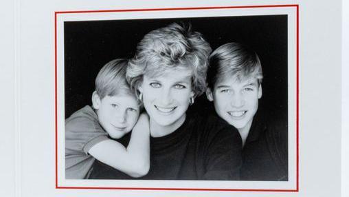 Diana, the then Princess of Wales, featured smiling in her Christmas card of 1995, with younger son, Harry, leaning on her right shoulder and William sitting to her left. The photo is in black and white.