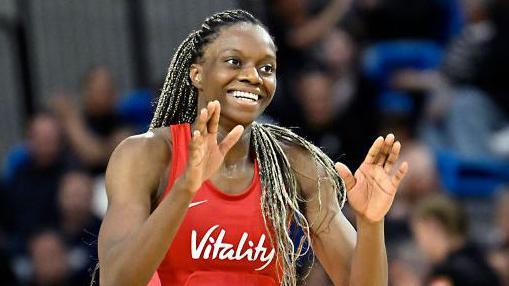 England player Funmi Fadoju smiling in a game.