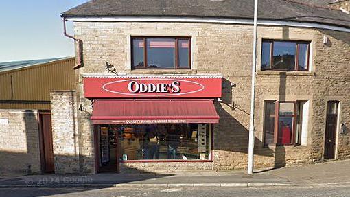 External view of Oddie's bakery shopfront with Oddie's red and white sign in Nelson, Lancashire