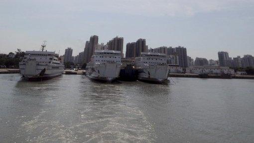 In this photo released by China's Xinhua News Agency, passenger ship Wuzhishan, centre, leaves from Xiuying port for Vietnam to evacuate nationals affected by anti- China violence, in Haikou, China's south most province of Hainan, Sunday, 18 May 2014