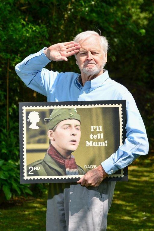 Ian Lavender holding his stamp