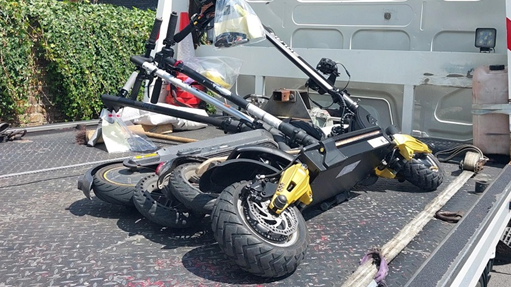 Four e-scooters kept on the back of a lorry ready to be seized 