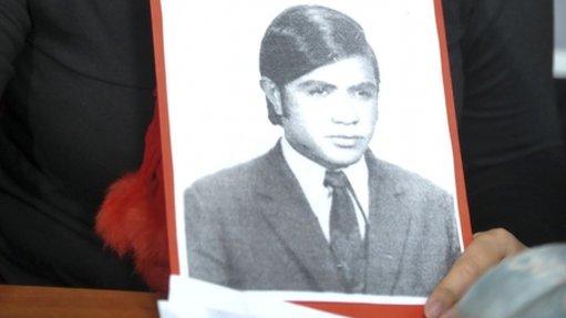 Victoria Montenegro holds a photograph of her father