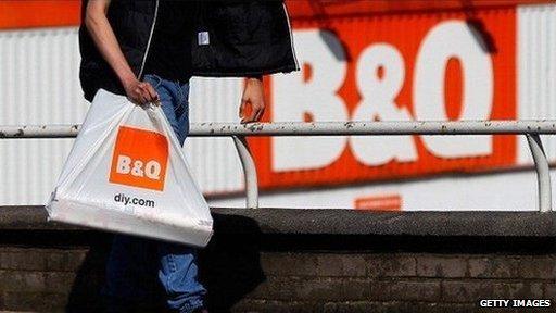 Shoppers walking past a B&Q store