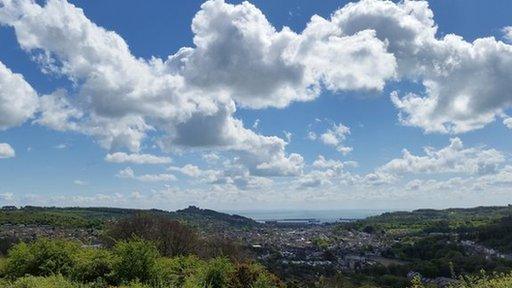 Cotton wool clouds over landscape