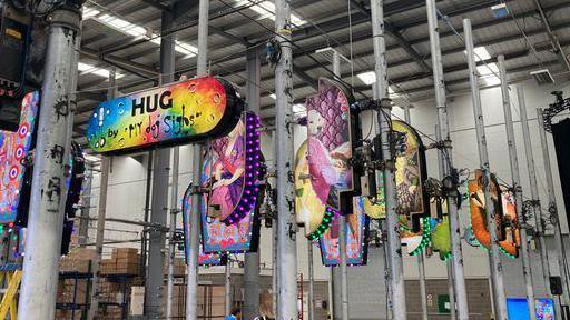 Different multi-coloured capsule shaped works on poles in Blackpool Illuminations' design workshop . Displayed are several of the 12 versions of the artist My Dog Sighs' Everyman character.