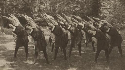 Students at Dartford exercise together, wearing the gym slips designed at the college, with everyone leaning to their right with left arms raised