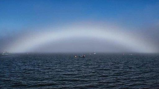 White rainbow over water