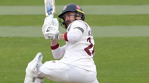 Lancashire batsman Josh Bohannon going down on one knee to pull the ball to the boundary against Northamptonshire.