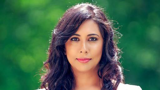A head and shoulders shot of Meera Naran, who is looking directly at the camera. 