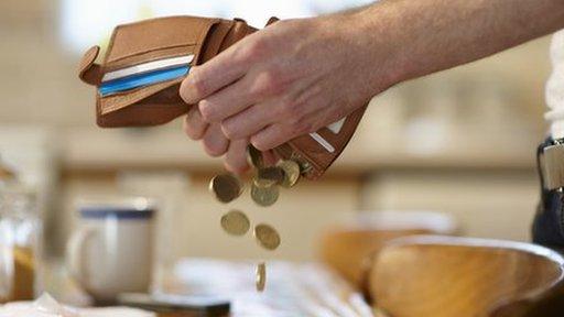 Man emptying wallet on a table