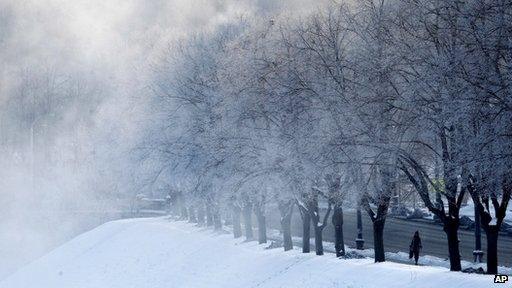 A woman walk on the street in the Vilnius, Lithuania,Thursday, Feb. 2, 2012, as morning temperatures plummeted to -30 Celsius (-22 degrees Fahrenheit).