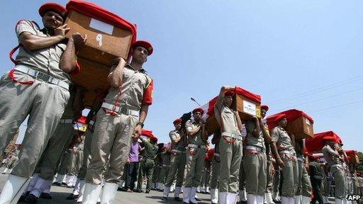 Egyptian soldiers carry the coffins of their comrades killed in an attack in Sinai during their funeral in Cairo on August 7, 2012.