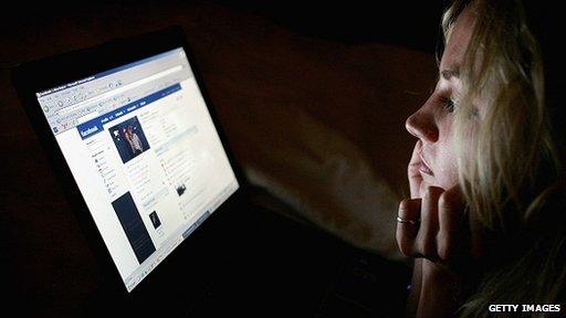 Teenager looks at Facebook