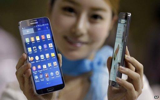 Model poses with Samsung smartphones