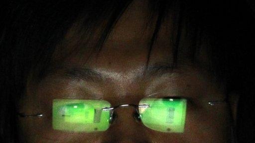 A Chinese hacker working on his laptop