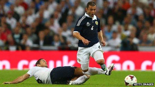 Frank Lampard of England tackles Shaun Maloney of Scotland