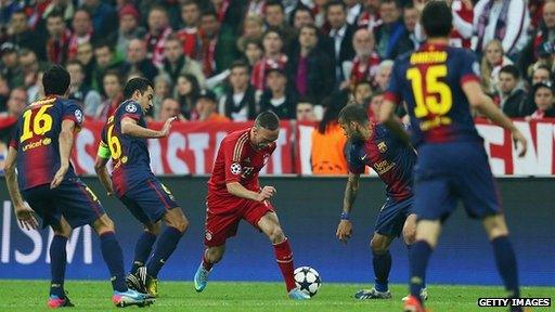 Franck Ribery of Bayern Munich is challenged by Sergio Busquets, Xavi and Daniel Alves