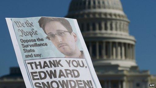 In this file photo dated 26 October 2013 shows demonstrators hold placards supporting former US intelligence analyst Edward Snowden during a protest against government surveillance in Washington DC