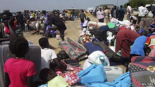 People displaced from fighting between the South Sudanese army and rebels wait for boats to cross the Nile River in Bor town