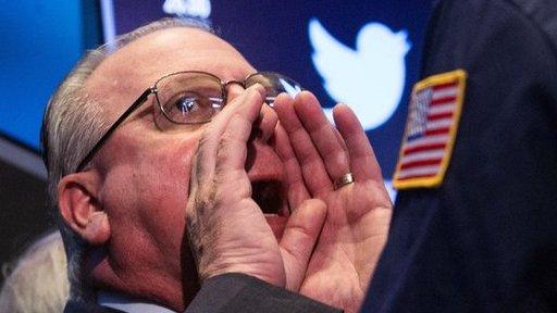 NYSE trader with Twitter logo behind him