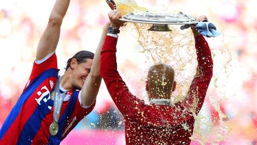 Bayern Munich manager Pep Guardiola is showered in beer after his team's final game of the season