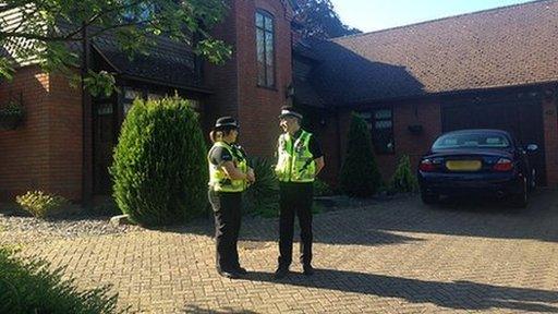 Police outside the home of Paul and Sandra Dunham