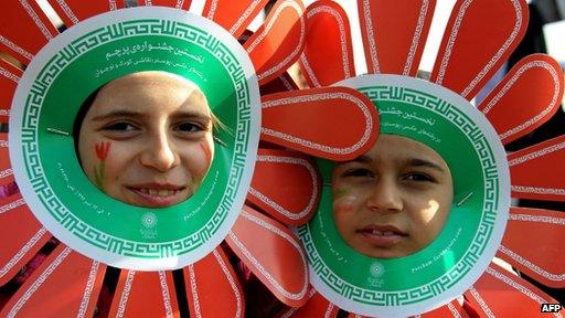 Iranian children wearing paper flowers