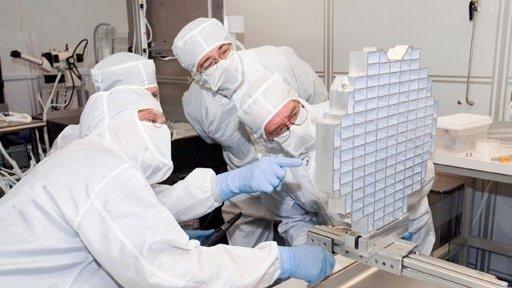 Scientists inspecting collector tray