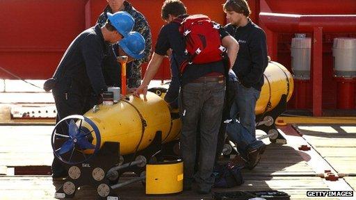 Australian technicians prepare to launch a vessel to search for MH370